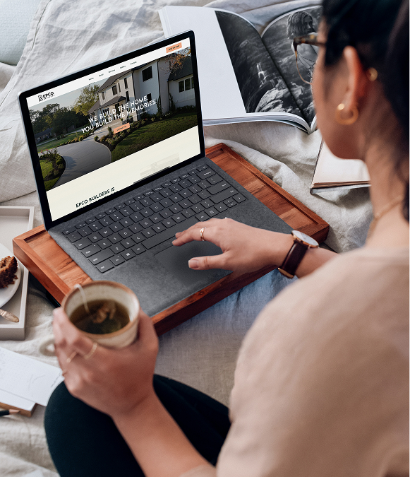 White label no-code website development — professional working on laptop with website page open