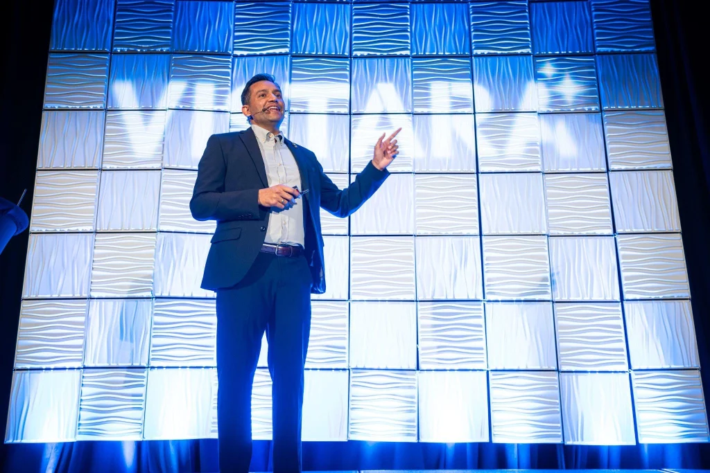 Vistara AI Event by E2M 2026, Ronik Patel as Speaker presenting on stage at an AI conference with The Agency AI Delivery Playbook: How the Operating Model for Agencies Is Changing in 2026, 2027