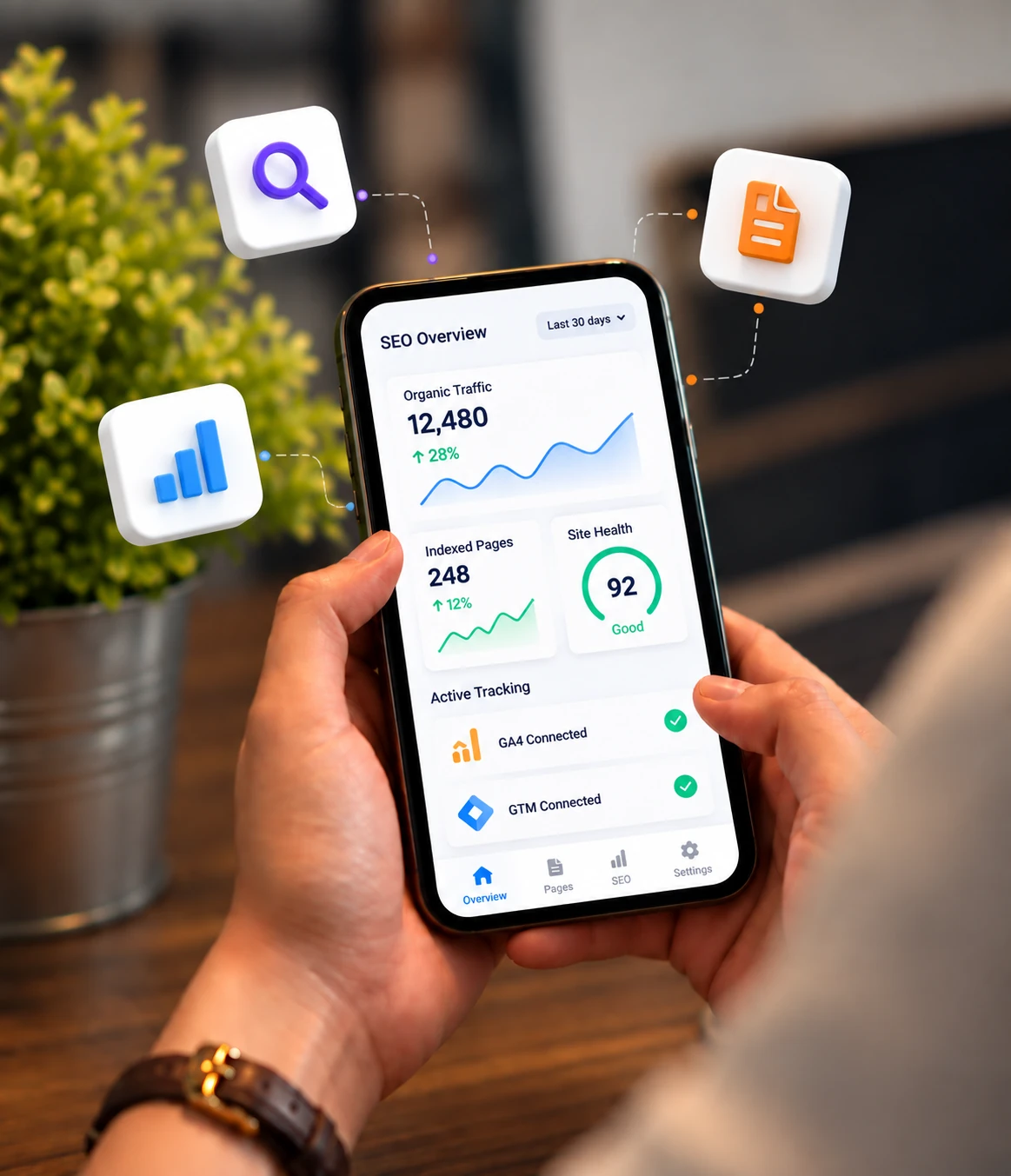 White label WordPress technical SEO and tracking support with site monitoring and performance reporting. Hands holding a phone with an SEO overview of organic traffic, indexed pages, site health and GA4 and GTM tracking