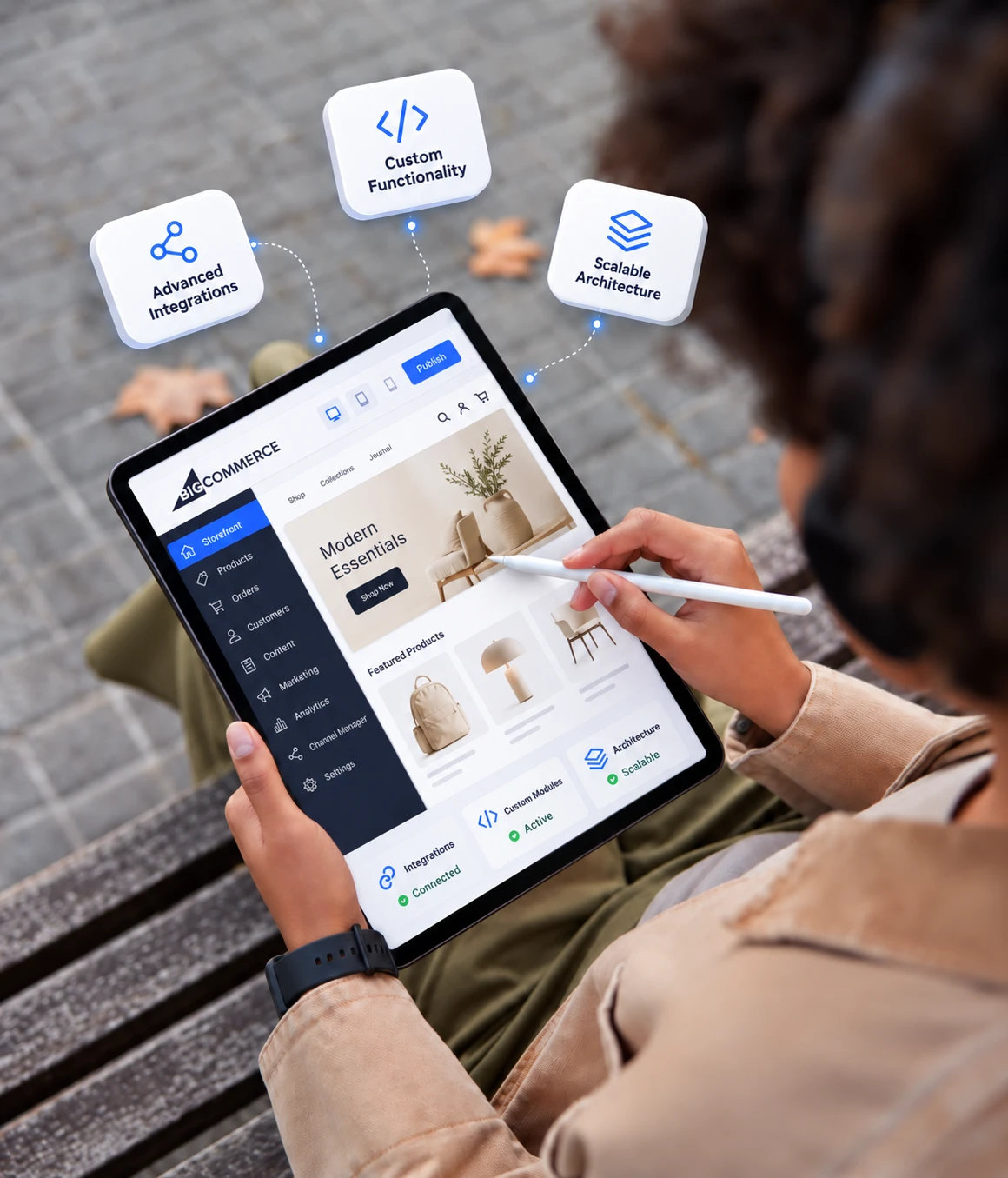 Hands editing a BigCommerce storefront on a tablet with custom functionality, advanced integrations and scalable architecture
